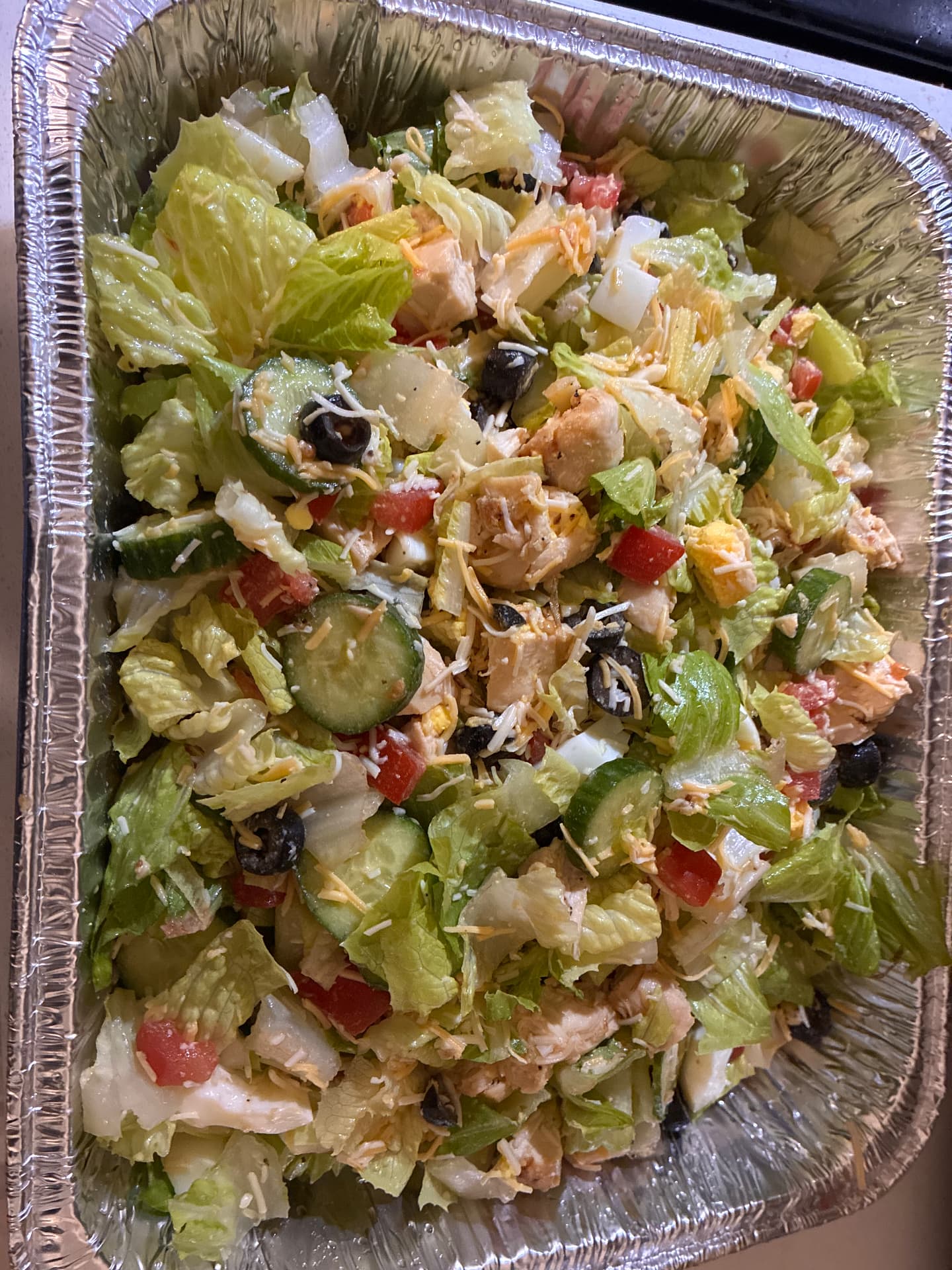 Large foil pan of Big Back salad with grilled chicken