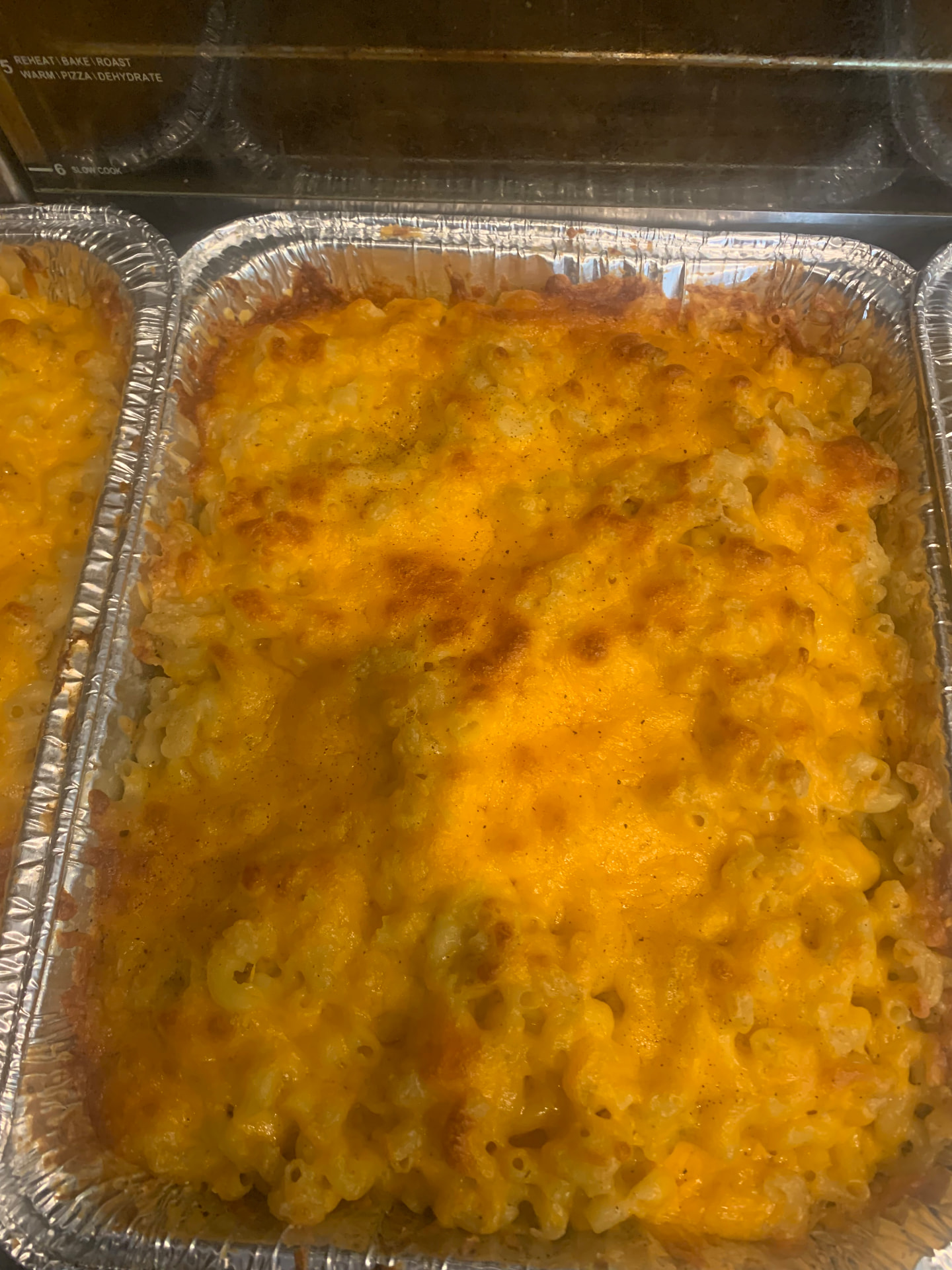 Full pan of baked macaroni and cheese with a golden cheddar top