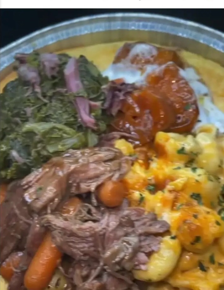 Soul food plate with roast, greens, macaroni and cheese, cornbread and yams