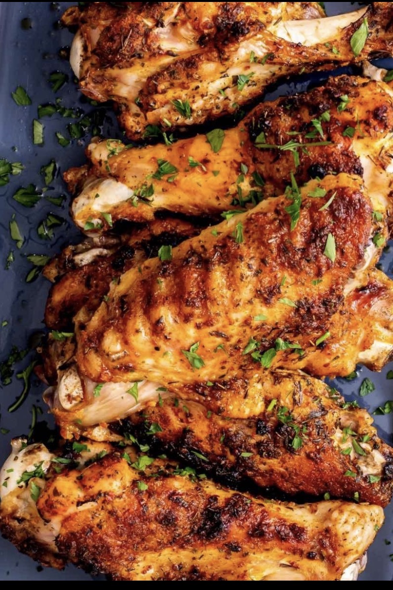 Roasted turkey wings seasoned and topped with fresh herbs